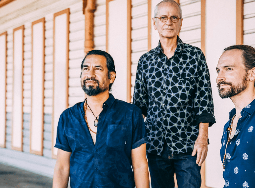 The three male members of Duende Indalo standing in front of the old wharf sheds in Fremantle.