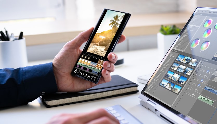 A smartphone and a laptop computer both show video editing software on their screens