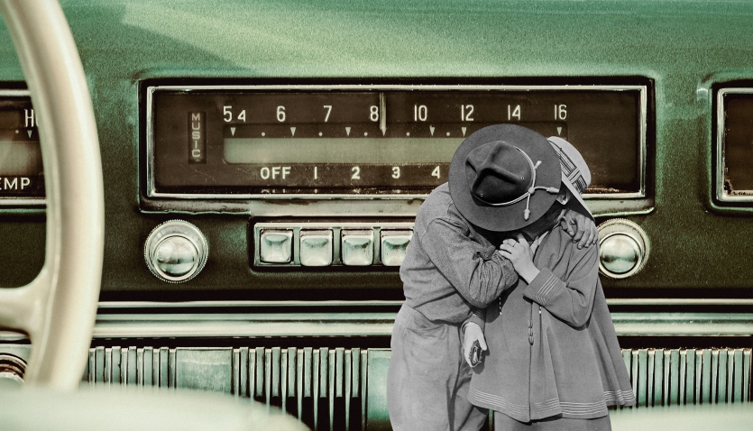 A stylised image of a 1950's car stereo with a black and white image of a man and woman kissing edited on top