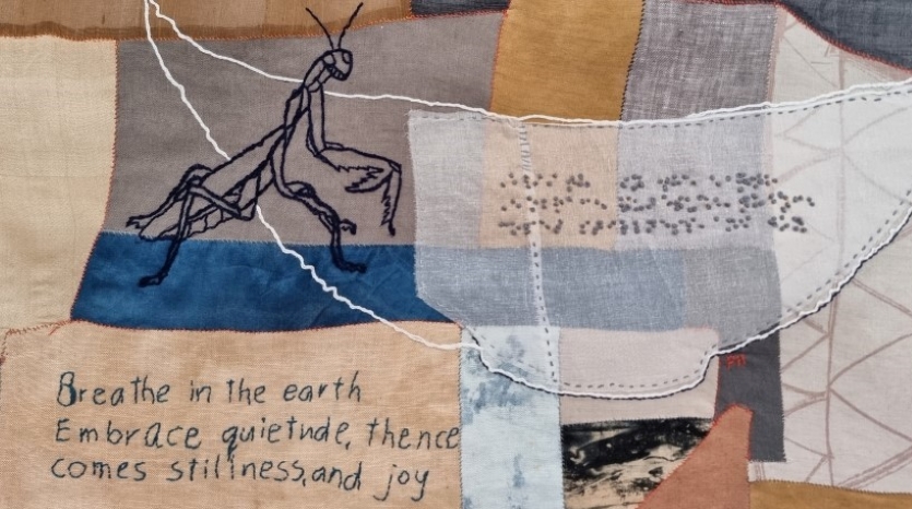 a textile art piece consisting of patches of blue, yellow and off-white fabrics, an embroidered stick insect and a brief poem