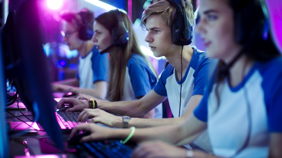 Group of teenages playing esport games on computers