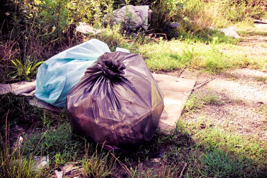 Filled garbage bags left in nature
