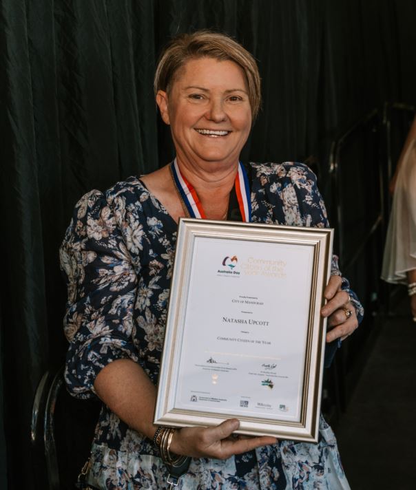 Natasha Upcott smiling with her award