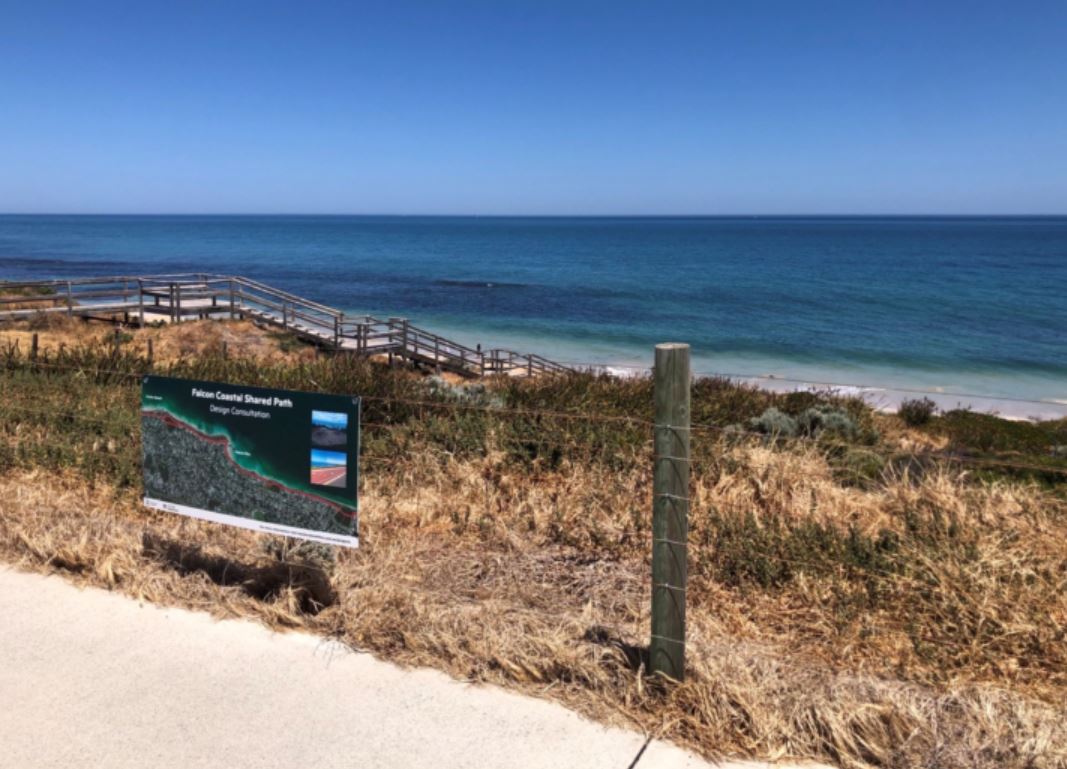 View of beach with grassy dunes in foreground