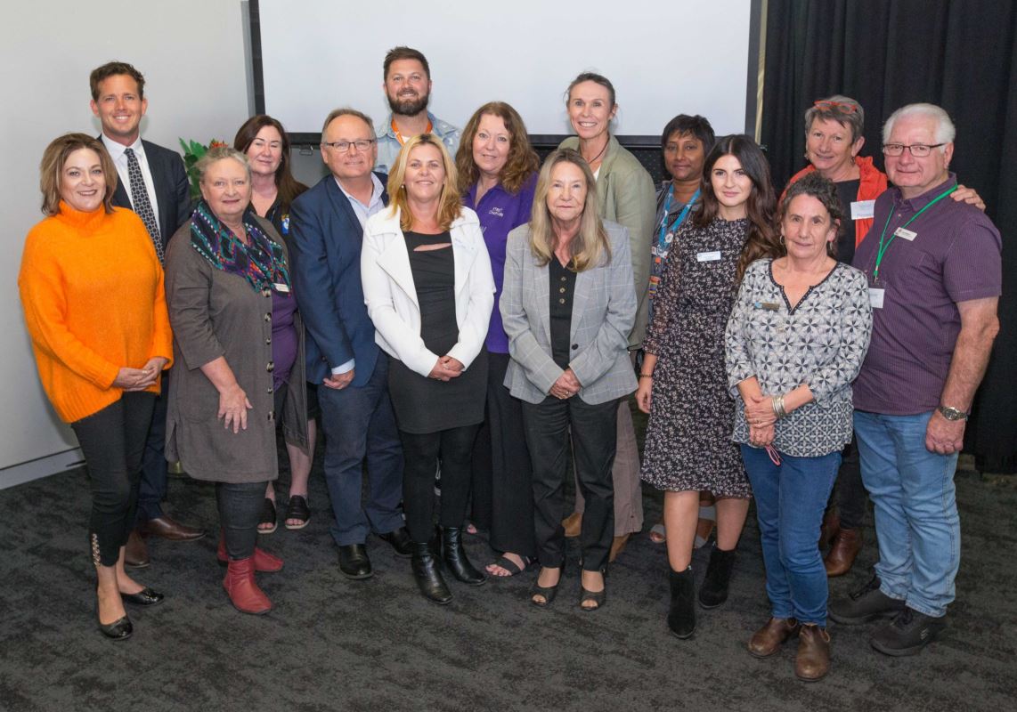 Community sector partners standing side by side at the Homelessness strategy launch