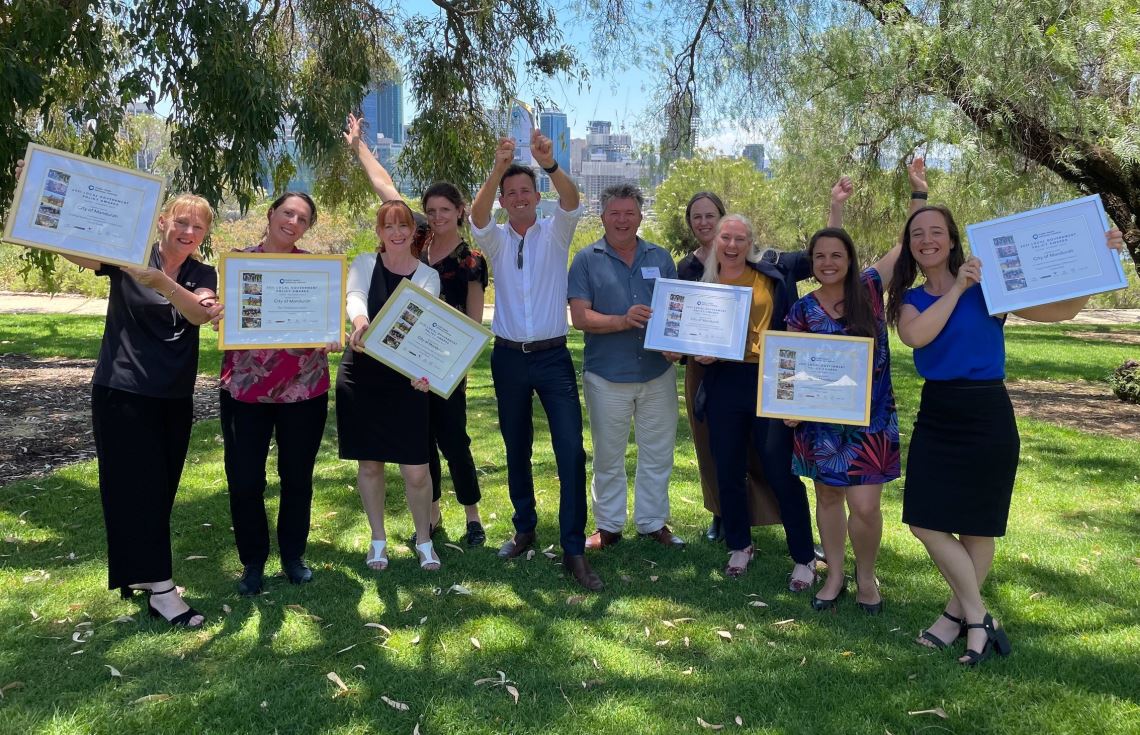 City of Mandurah staff members outside standing side by side holding awards