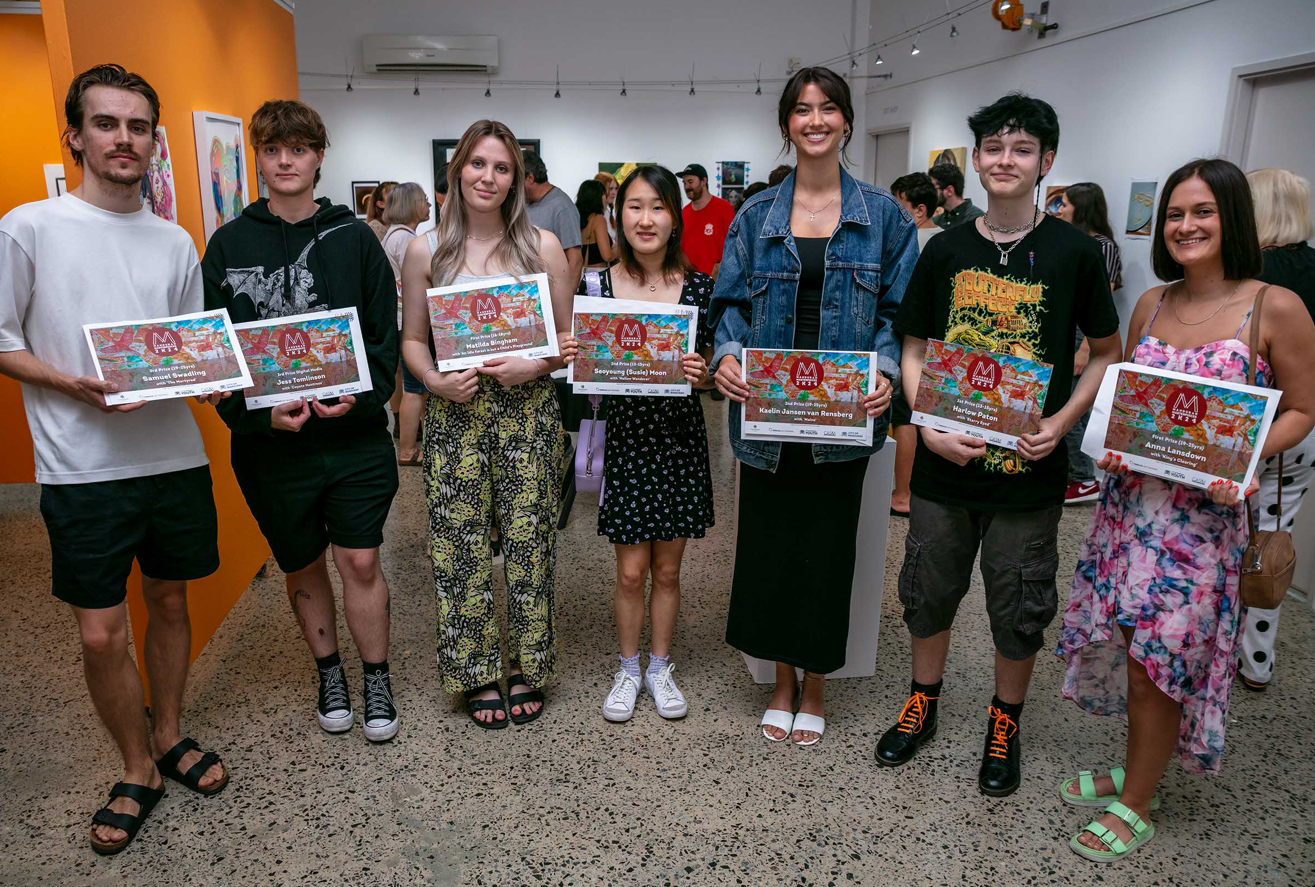 Young artists stand side by side with their awards