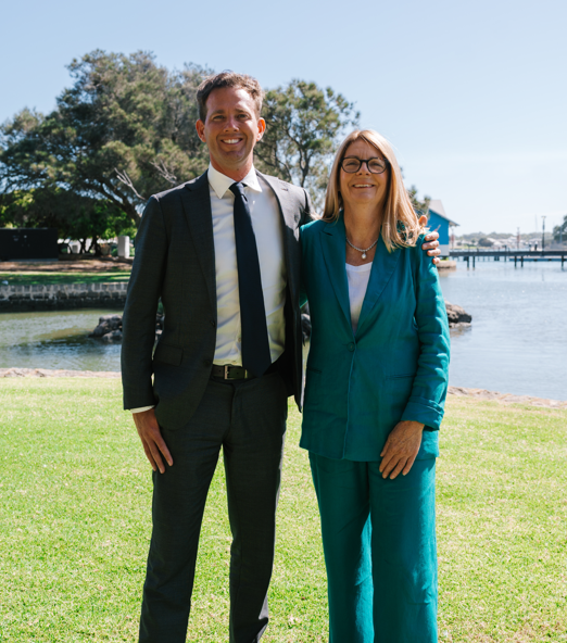 Rhys Williams and Caroline Knight stand side by side near the water