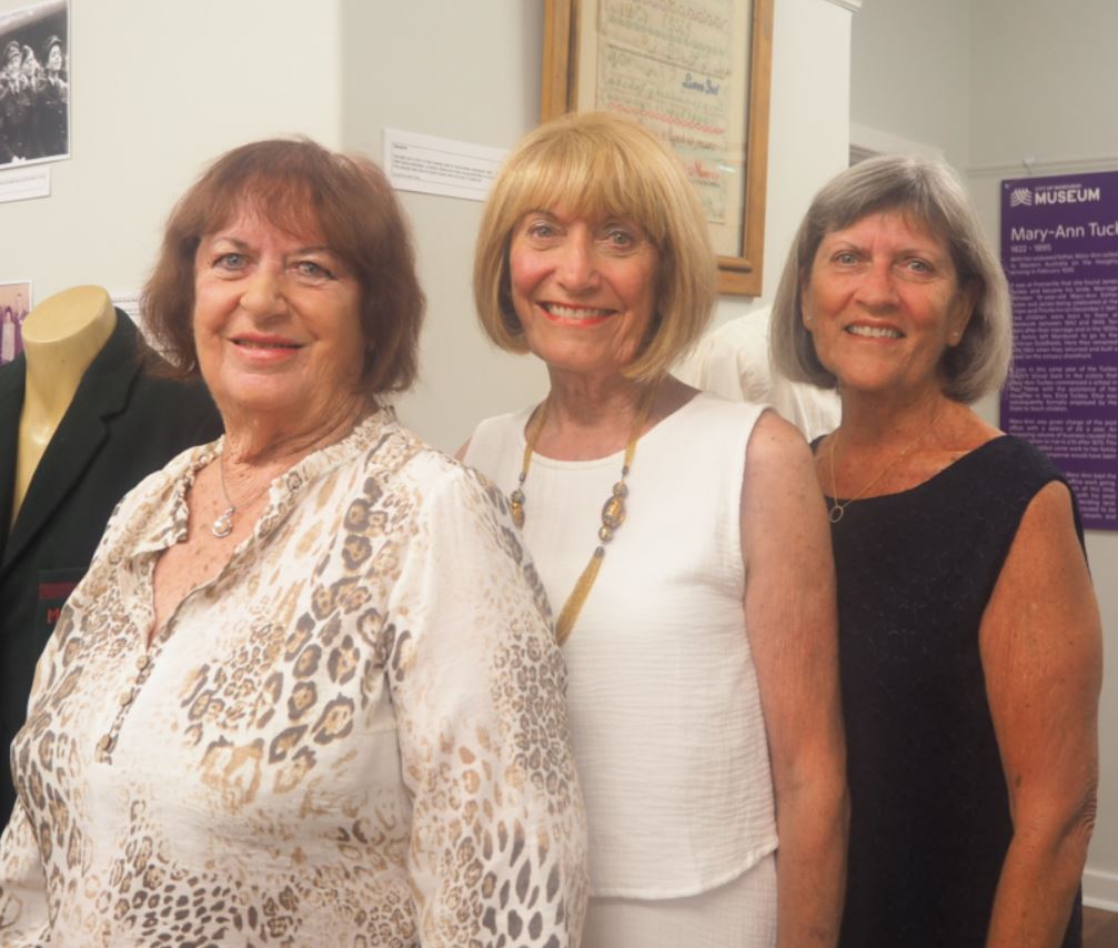 Three Tuckey women stand side by side and face camera