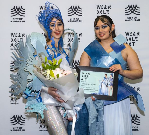 Two models stand side by side wearing blue and white wearable art creations 