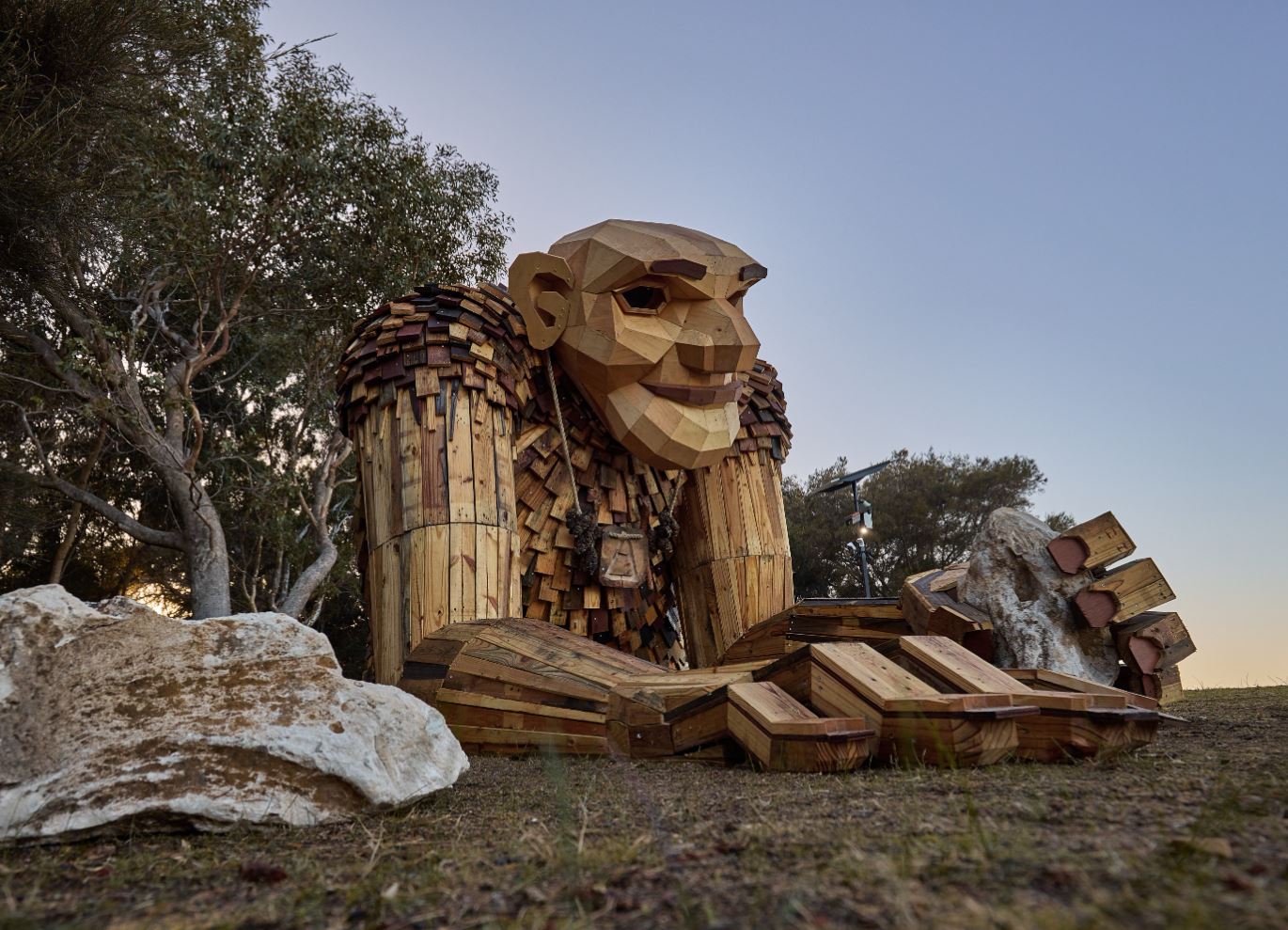 Giant of Mandurah Yaburgurt Cirkelstone lays on foreshore with rocks in foreground. Photo by Dan MacBride courtesy of FORM Building a State of Creativity.