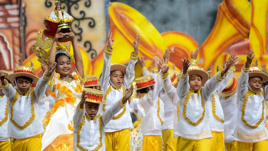Children in costume dancing and celebrating at a Barrio Fiesta.