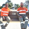 Irrigation Technicians Alan McKay and Russell Price sitting on the new sustainable park bench at Meadow Springs Sporting Facility