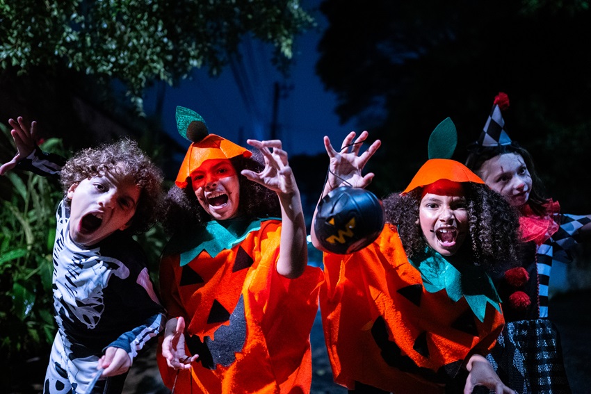 Children in halloween costume walking down the street