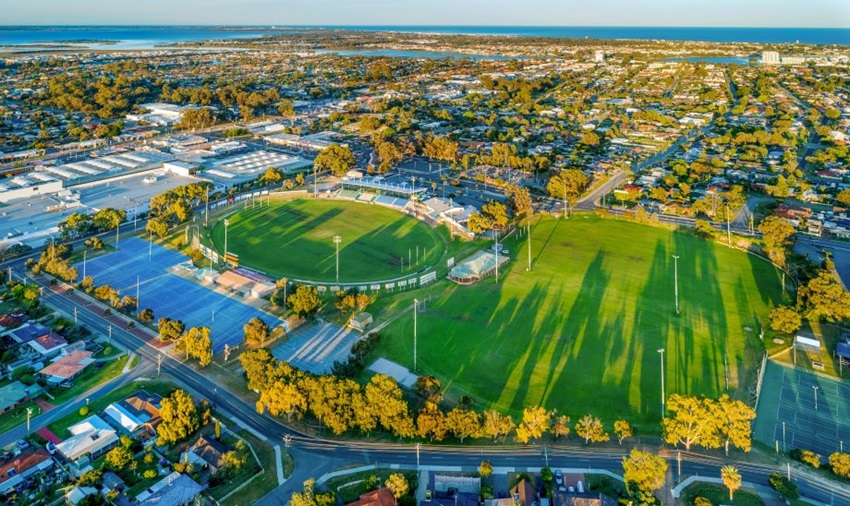 Aerial view overlooking Rushton Park sporting facilities showing three sporting fields, clubhouse and surrounding residential areas