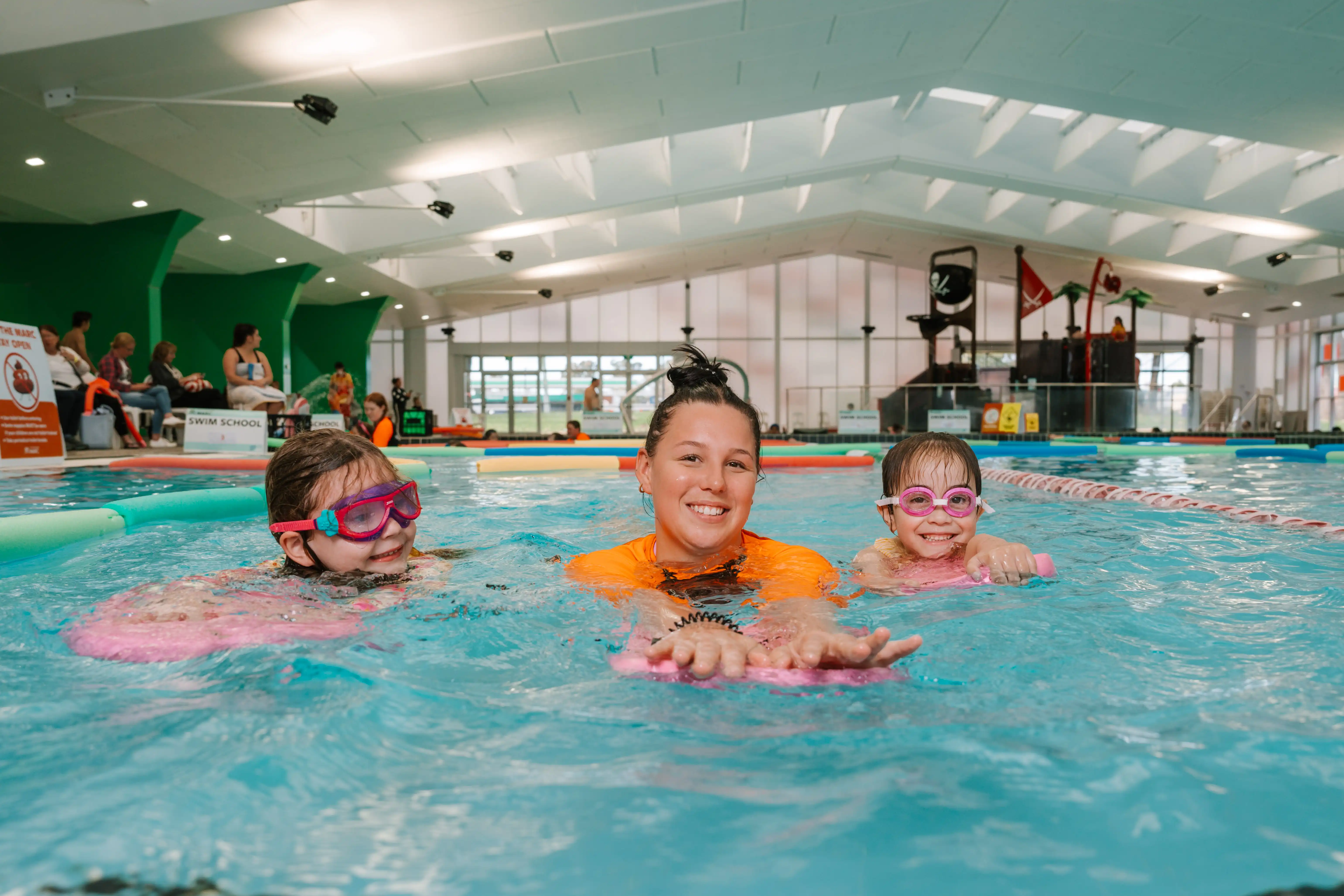 Children in pool with swim teacher. 