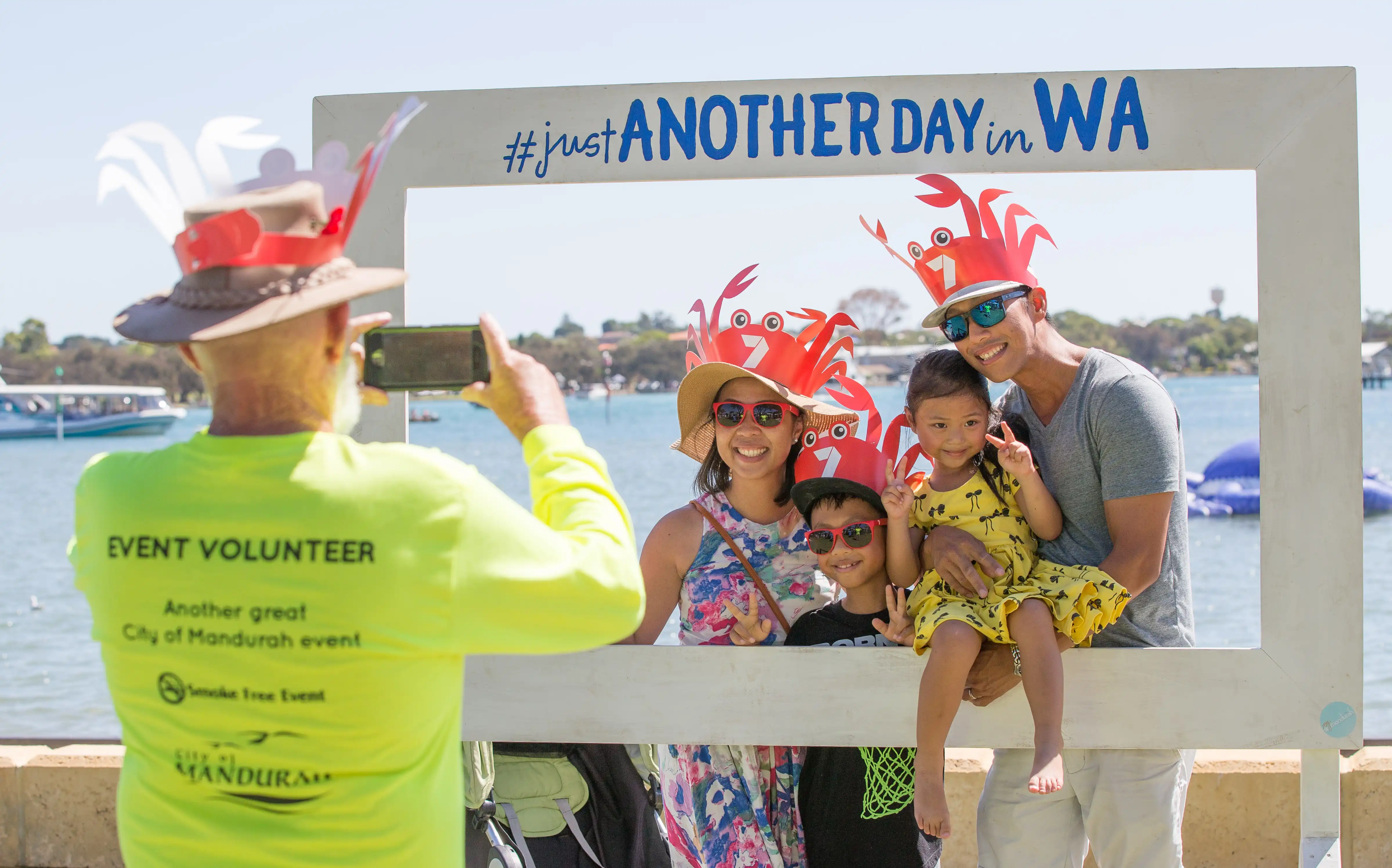 Volunteer taking photo of family at crabfest.