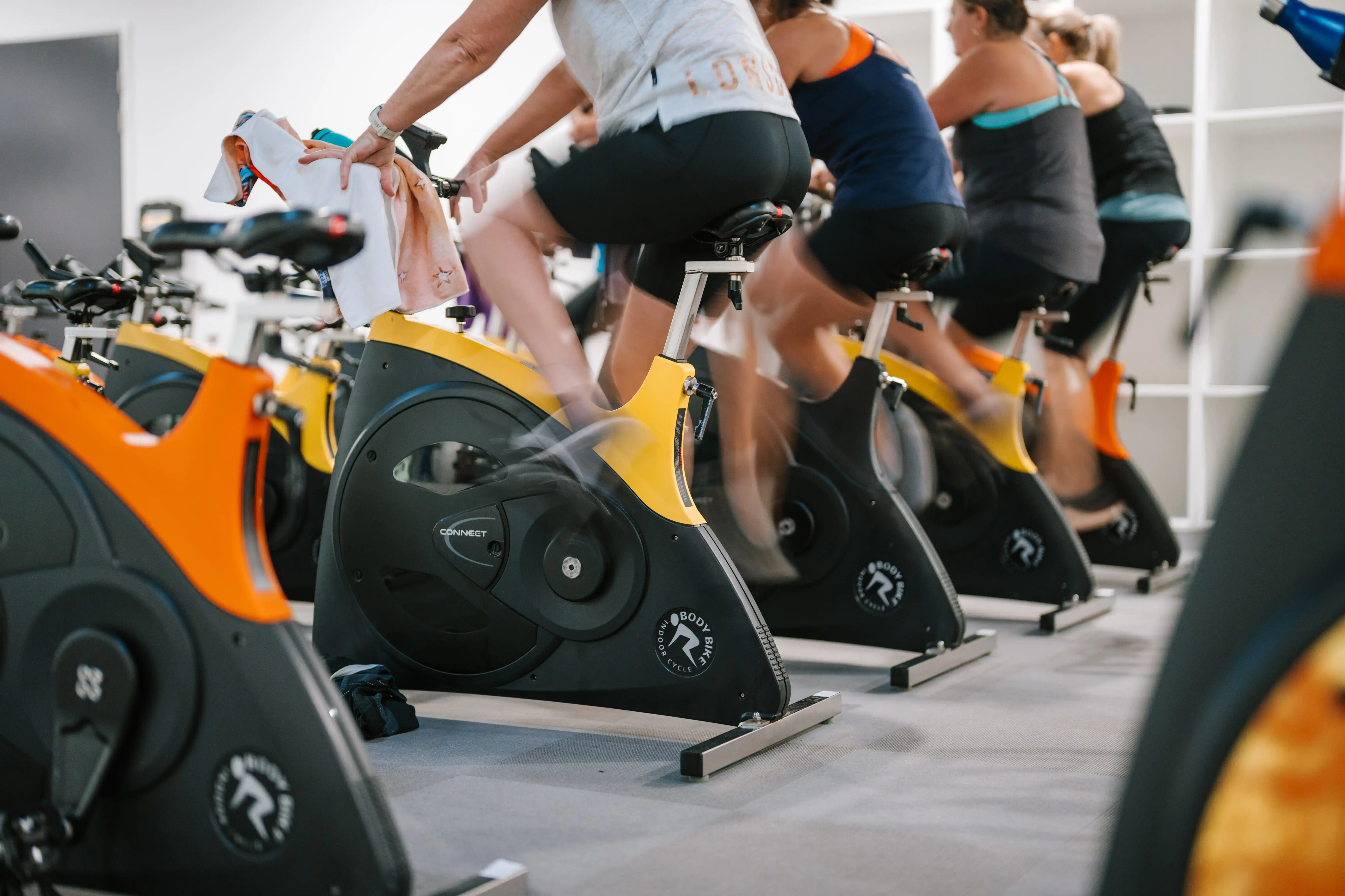People riding stationary bikes during a group spin class at the MARC.