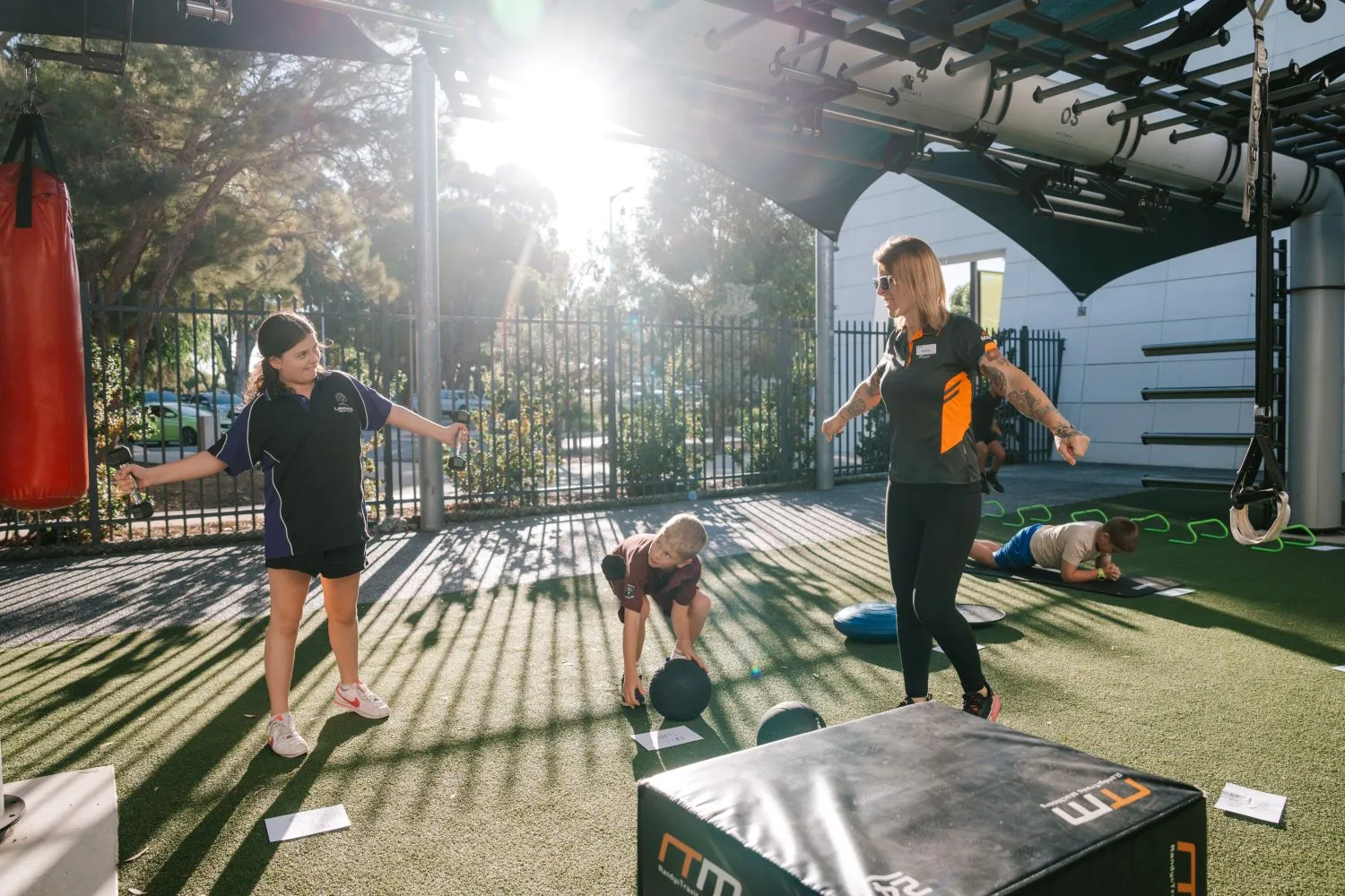 Trainer showing children how to exercise during PowerFit