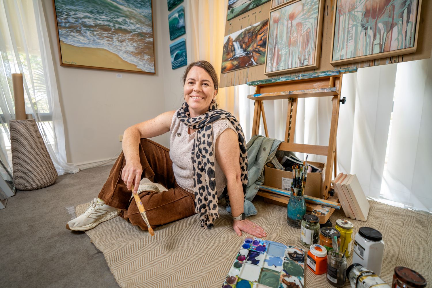 photo of artist Lucy Gray with art supplies
